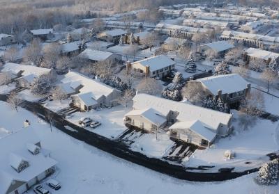 aerial shot of homes in snow