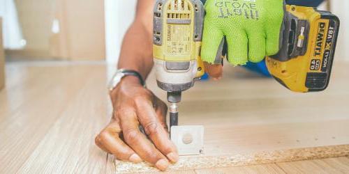 man drilling wood